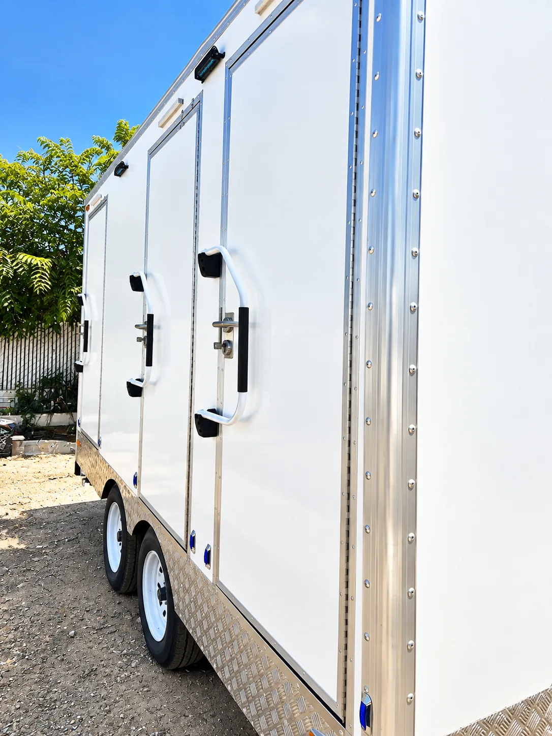 Private entrances on an unbranded restroom and shower combination trailer