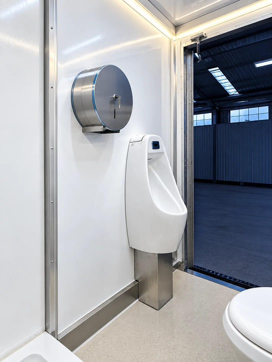 Urinal and sink area inside a temporary restroom trailer